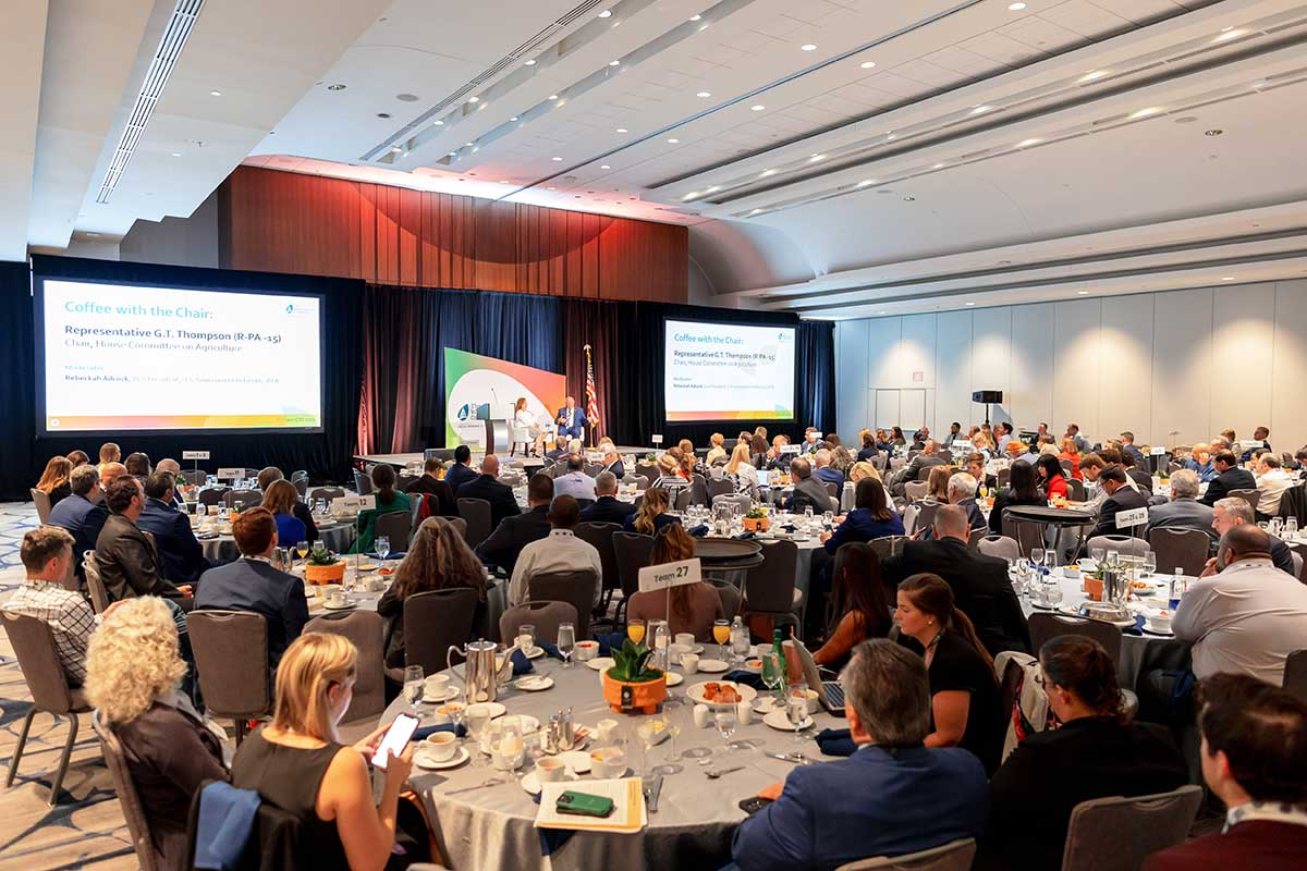 A ball room full of conference attendees listening to the session "Coffee with the Chair". 