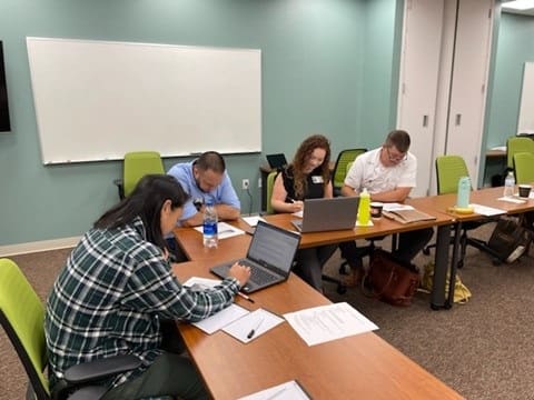 Produce Safety Immersion Program participants at desks in education 